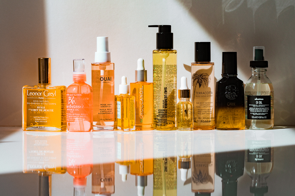 A lineup of hair oiling products from different brands.