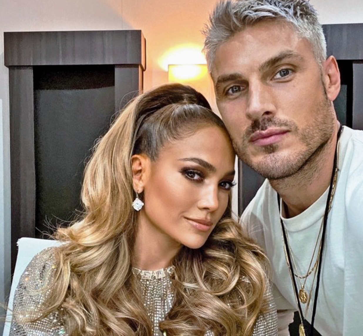 Image of jLo and Chris Appleton smiling with a beautiful head of hair