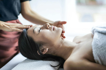 Image of a lady having a head massage.