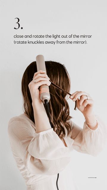 Woman with long hair demonstrating the third step in how to use the Tyme iron pro straightener and curler